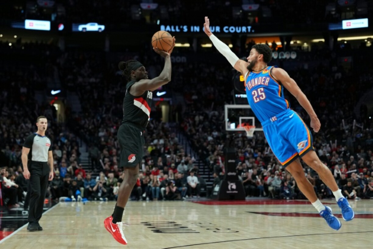 Jrue Holiday of the Portland Trail Blazers shoots over Ajay Mitchell in the Trail Blazers' NBA victory over the Oklahoma City Thunder