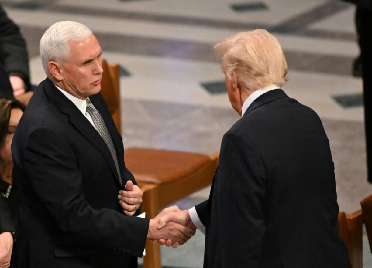 Mike Pence (L) and Donald Trump (R) shared a brief moment of reconciliation at Jimmy Carter's funeral