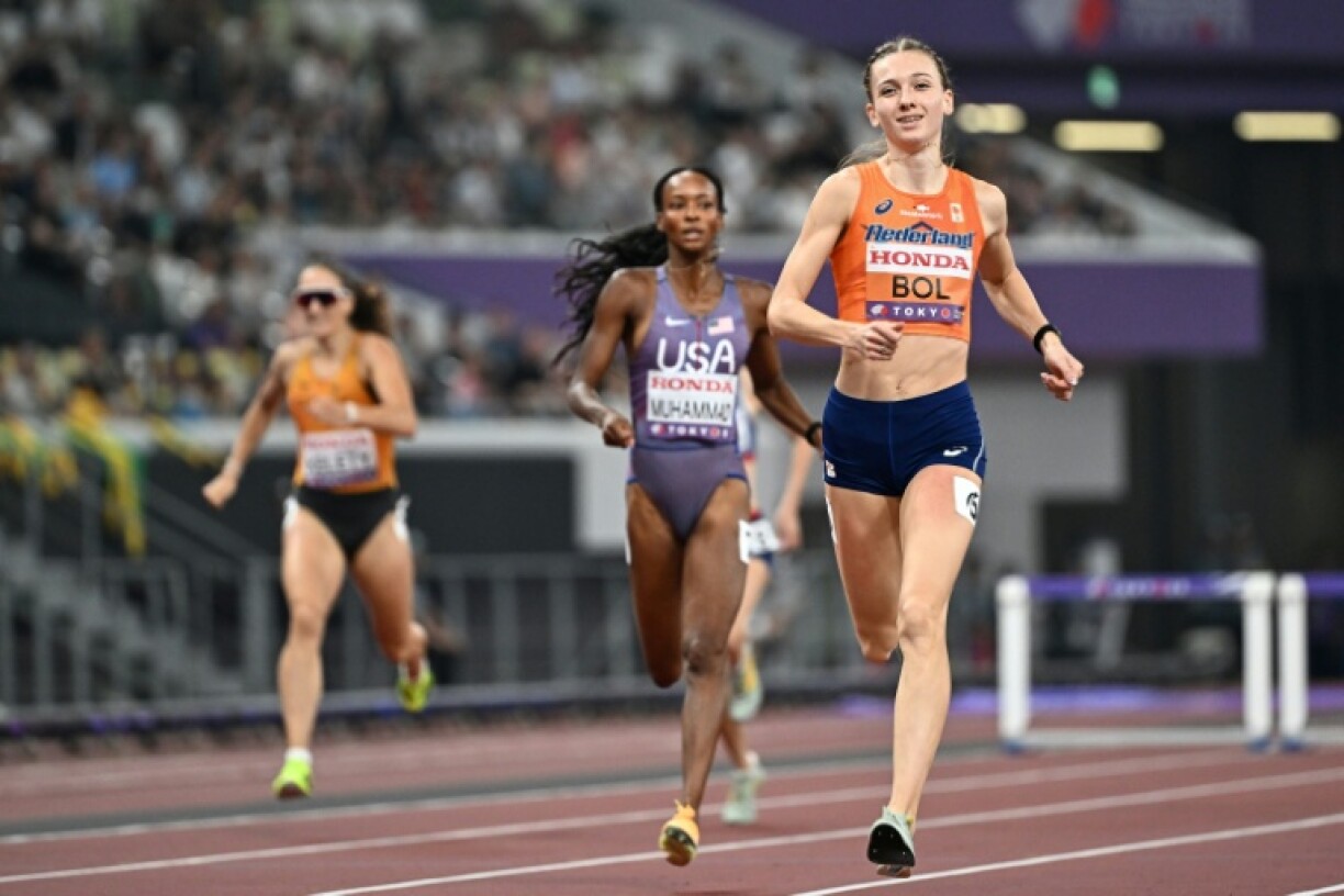 USA's Dalilah Muhammad (C) and Netherlands' Femke Bol (R)