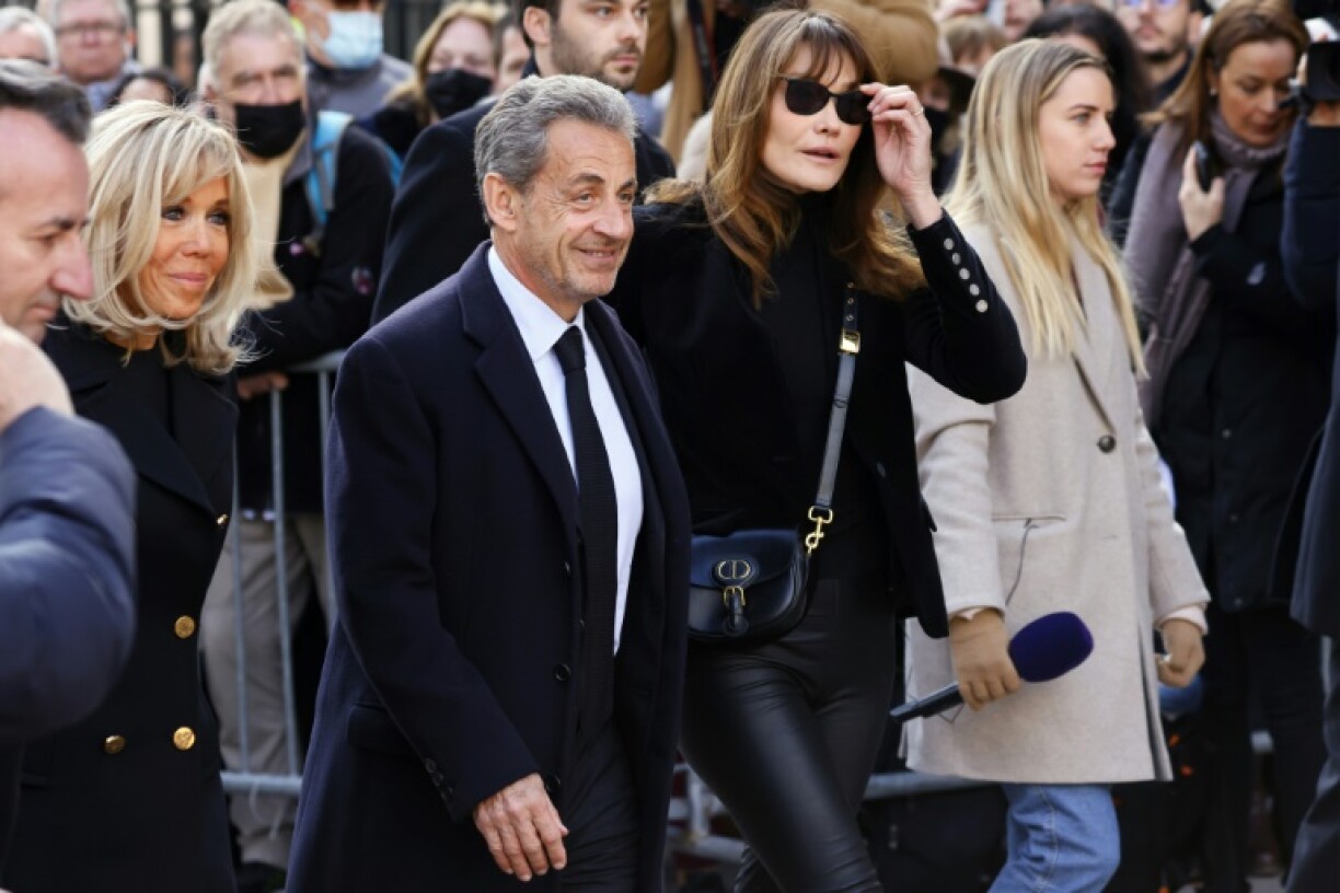 Sarkozy's marriage to former model Carla Bruni (2nd R) has kept him in the news
