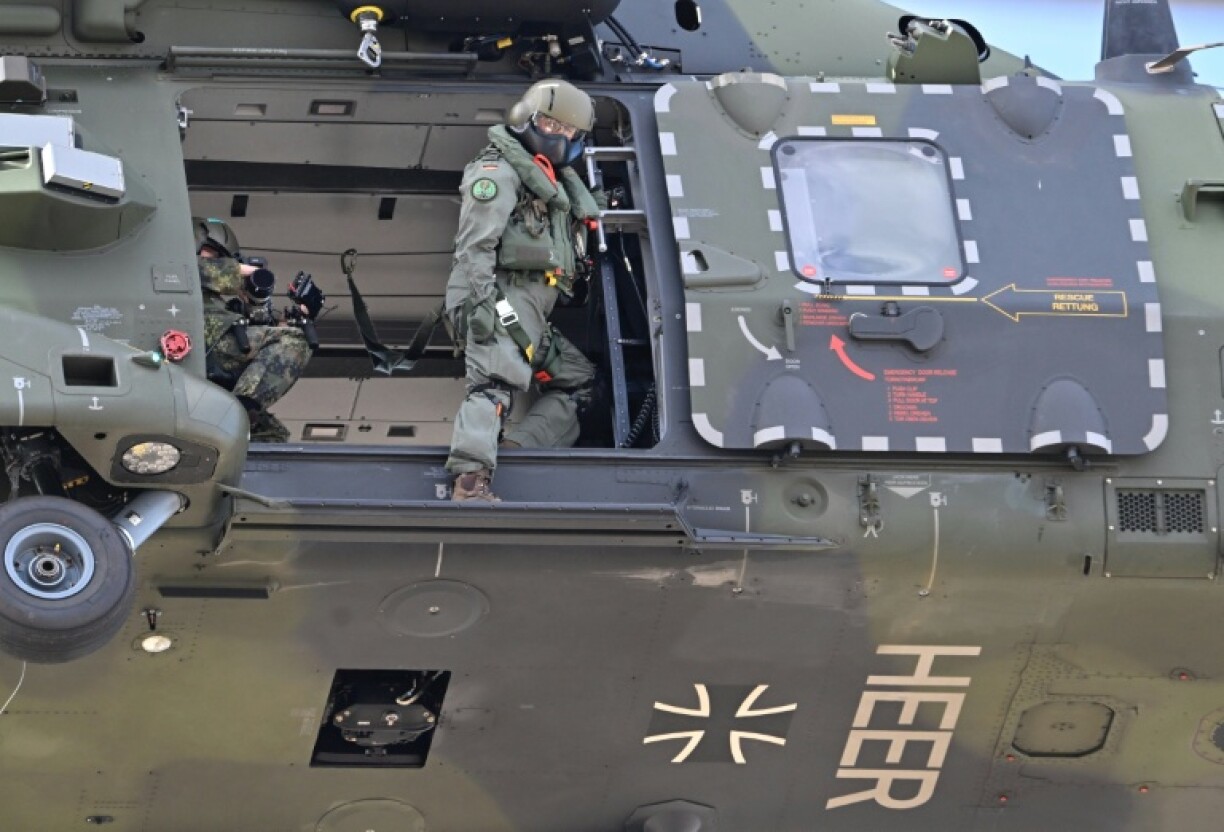 A German soldier aboard a NH90 transport helicopter of the German armed forces at Hamburg harbour during the Red Storm Bravo exercise