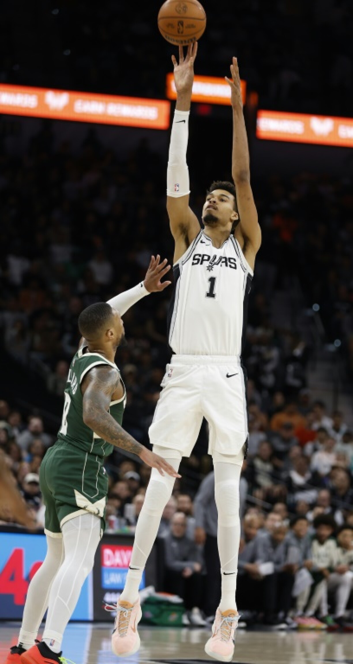 Victor Wembanyama shoots over Damian Lillard in San Antonio's defeat of Milwaukee on Friday