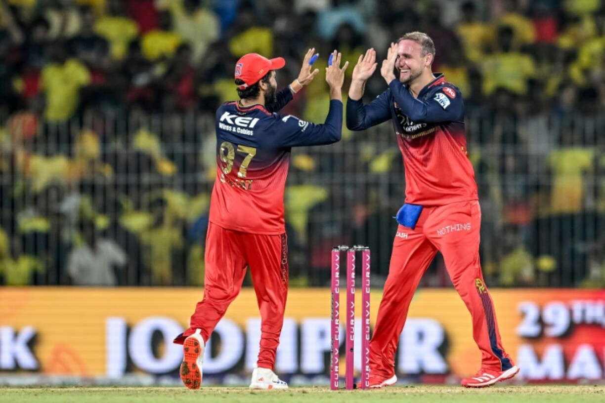 That's out: Royal Challengers Bengaluru's Liam Livingstone (R) celebrates with captain Rajat Patidar after taking the wicket of Chennai Super Kings' Sam Curran