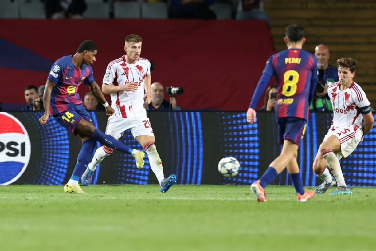 English forward Marcus Rashford scores Barcelona's fourth goal in their rout of Olympiacos