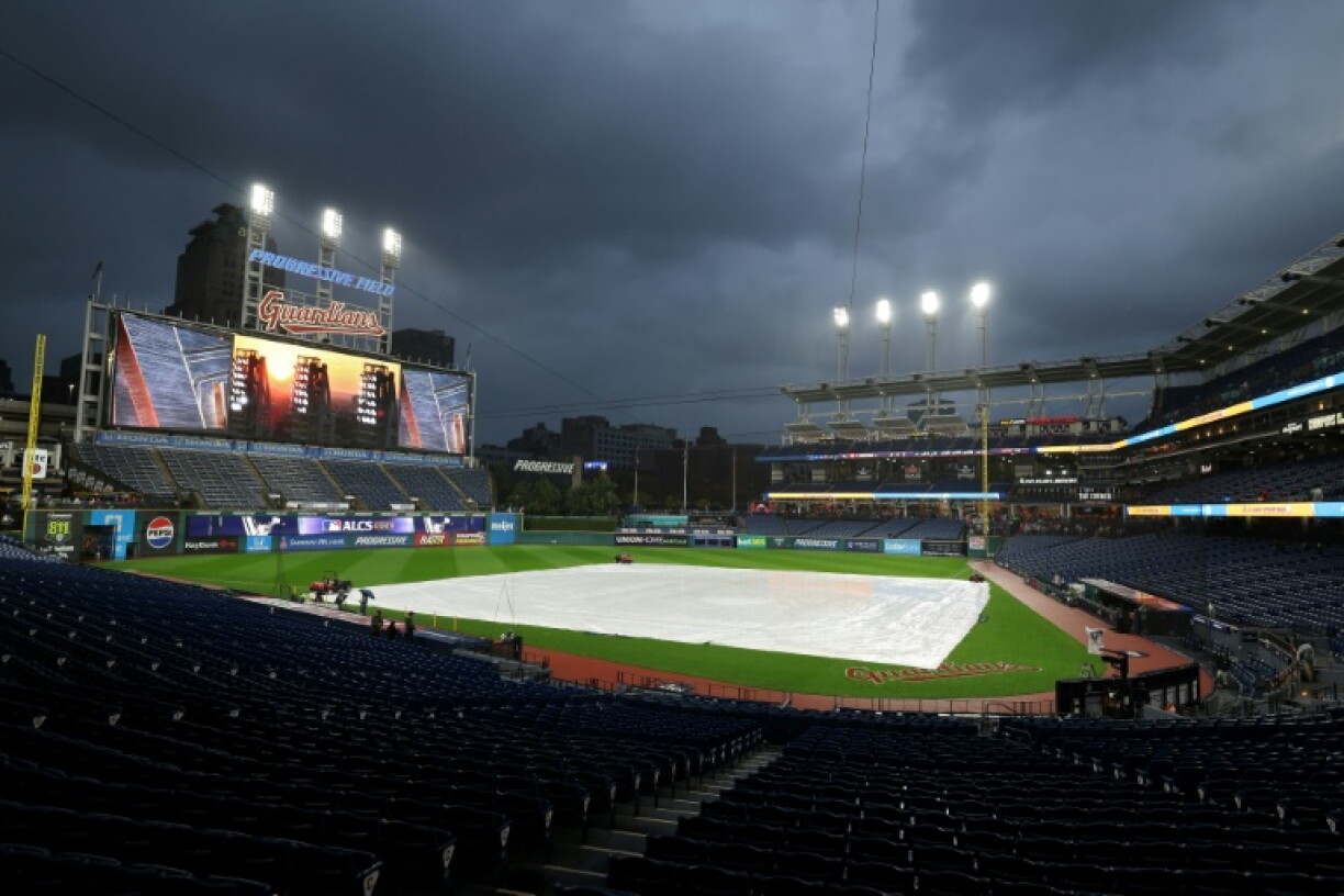 A tarp covers the infield at Progressive Field prior to the rain-delayed MLB playoff game between the Cleveland Guardians and Tampa Bay Rays