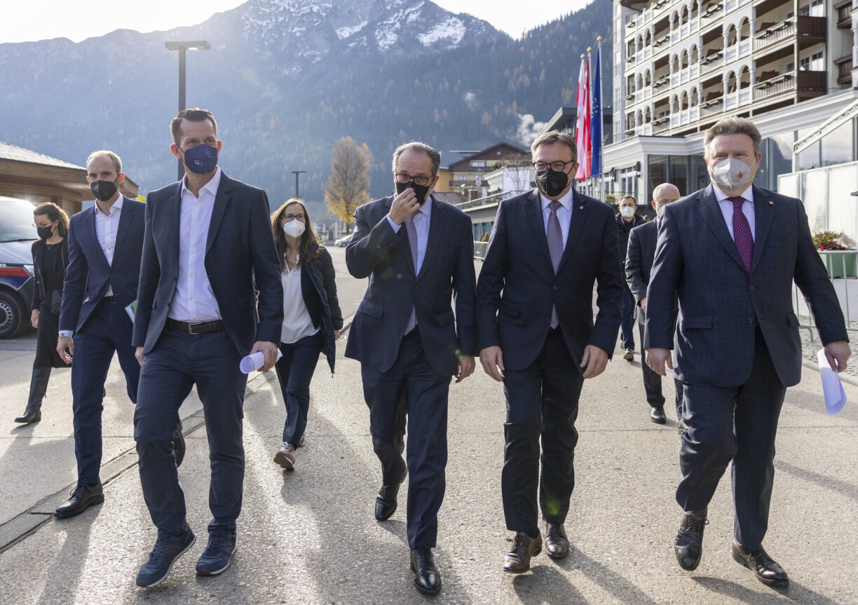 (L-R) Austrian Health Minister Wolfgang Mueckstein, Chancellor Alexander Schallenberg, Tyrol Governor Guenther Platter and the President of the Austrian Association of Cities Michael Ludwig on their way to address a press conference on November 19, 2021 in Pertisau, Tyrol, Austria.