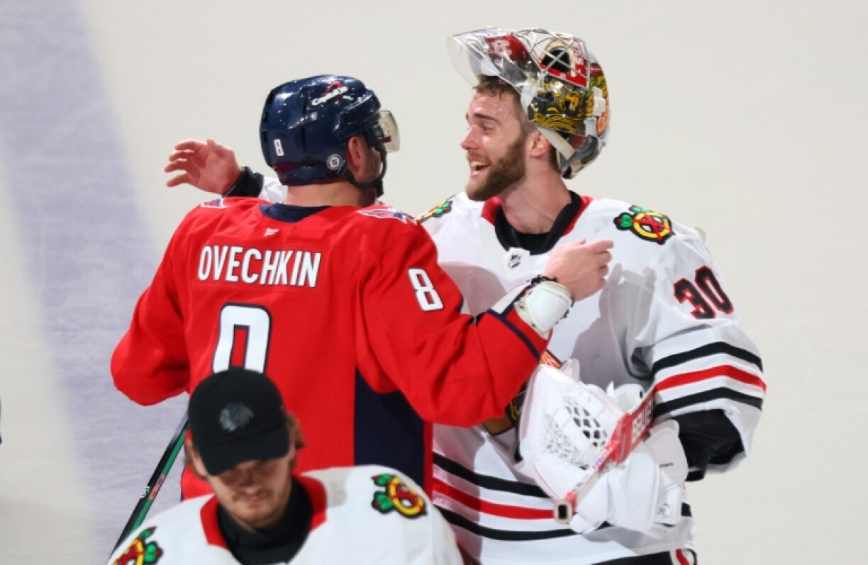 Russian Alex Ovechkin of the Washington Capitals shares a hug with Chicago goalie Spencer Knight after scoring twice in a game against the Blackhawks to tie Wayne Gretzky's all-time NHL goal record