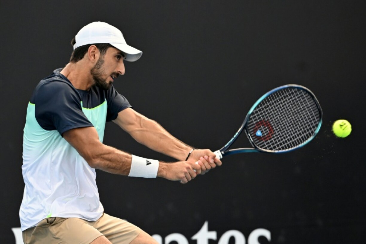Lebanon's Hady Habib hits a shot against China's Bu Yunchaokete on court 13 at the Australian Open