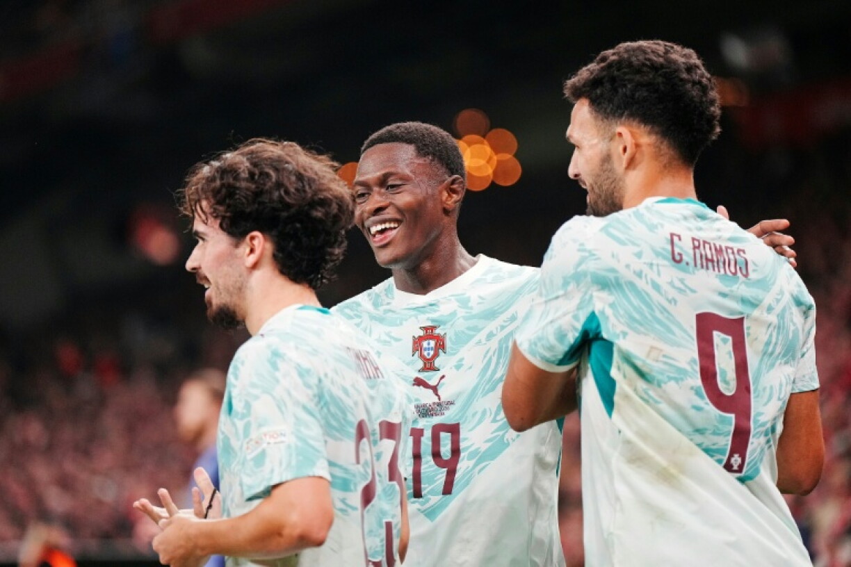 Portugal players celebrate after scoring one of their goals in a 4-2 victory away to Denmark