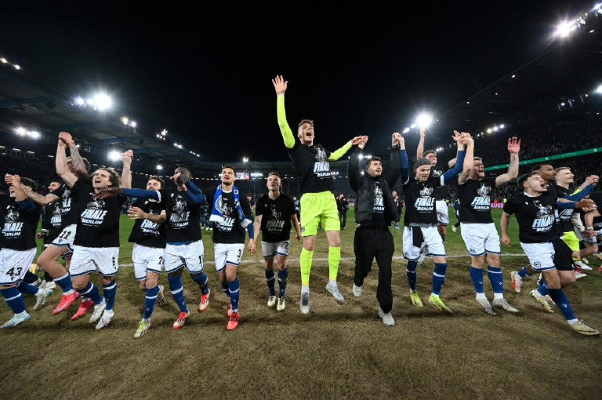 Arminia Bielefeld players celebrate after defeating Bayer Leverkusen to make the German Cup final