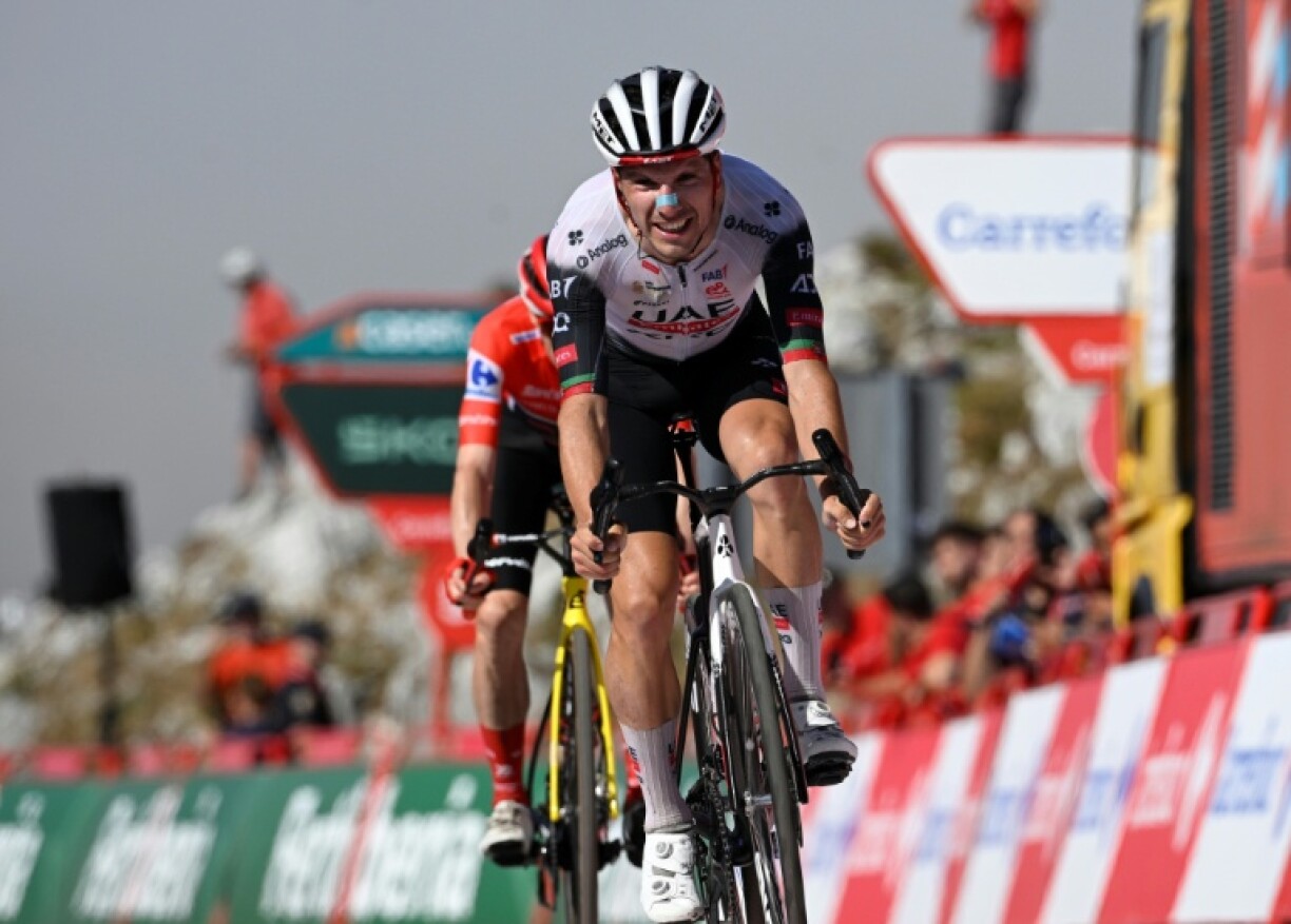 Team UAE's Portuguese rider Joao Almeida crosses the finish line first in stage 13 of the Vuelta a Espana