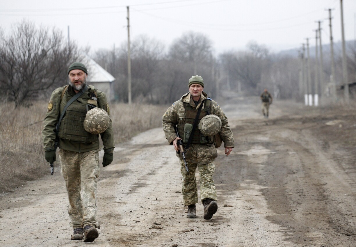 Ukrainian servicemen patrol in the settlement of Troitske in the Lugansk region near the front line with Russia-backed separatists on February 22, 2022.