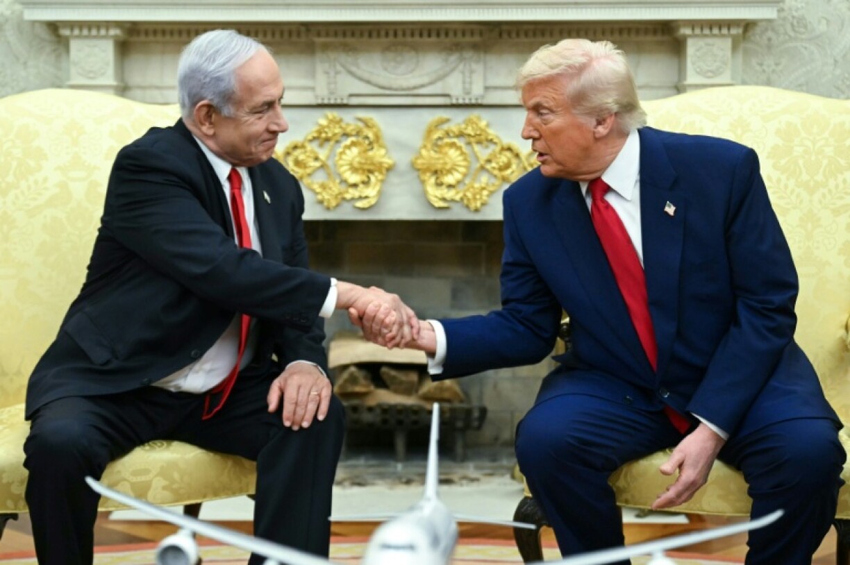 US President Donald Trump shakes hands with Israeli Prime Minister Benjamin Netanyahu during an Oval Office meeting