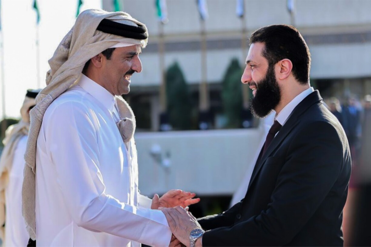 Syria's interim president Ahmed al-Sharaa bids farewell to Qatar's Emir Sheikh Tamim bin Hamad Al-Thani as he departs Damascus