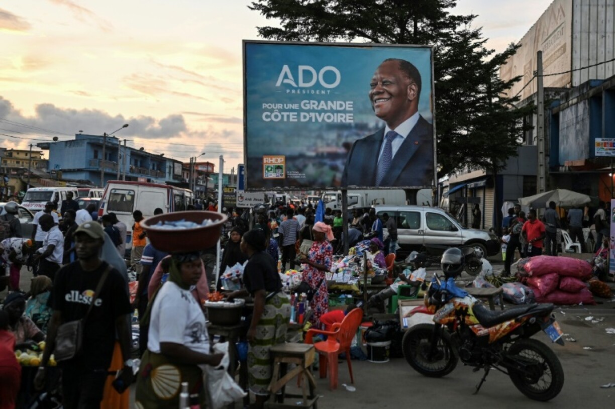 A billboard at a market in Abobo, an Abidjan suburb, shows poll favourite Alassane Ouattara