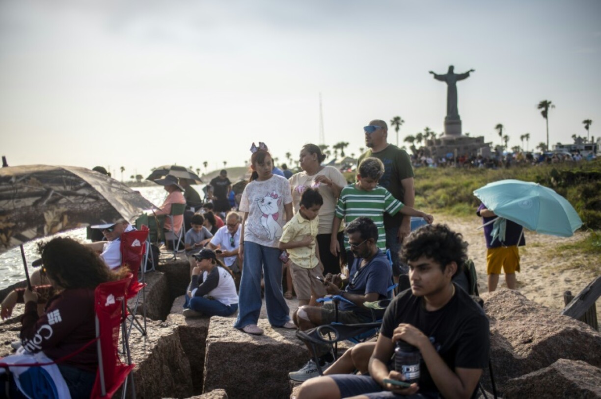 People wait on South Padre Island to watch the SpaceX Starship rocket launch from Starbase, Texas, on May 27, 2025