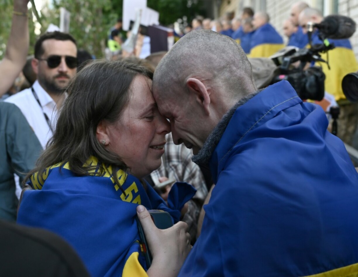 A freed Ukrainian prisoner embraces his wife in the Chernygiv region on Friday