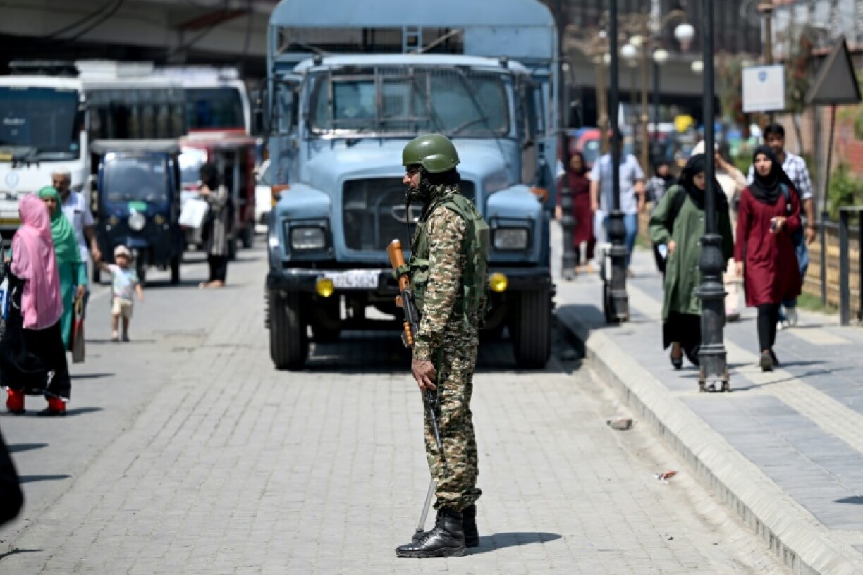 An Indian paramilitary soldier stands guard along a street in Srinagar on May 14, 2025