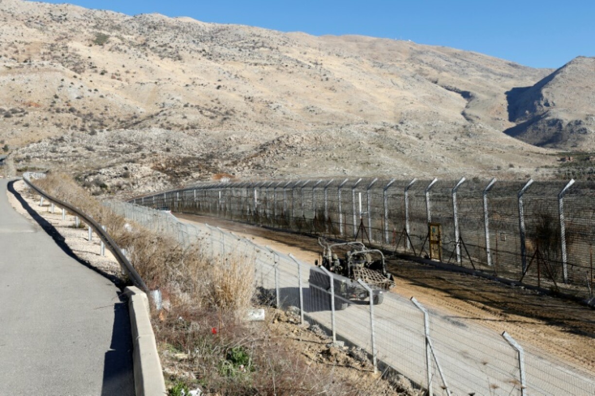 An Israeli army vehicle patrols near the fence leading into the UN-patrolled buffer zone separating Israeli and Syrian forces on the Golan Heights