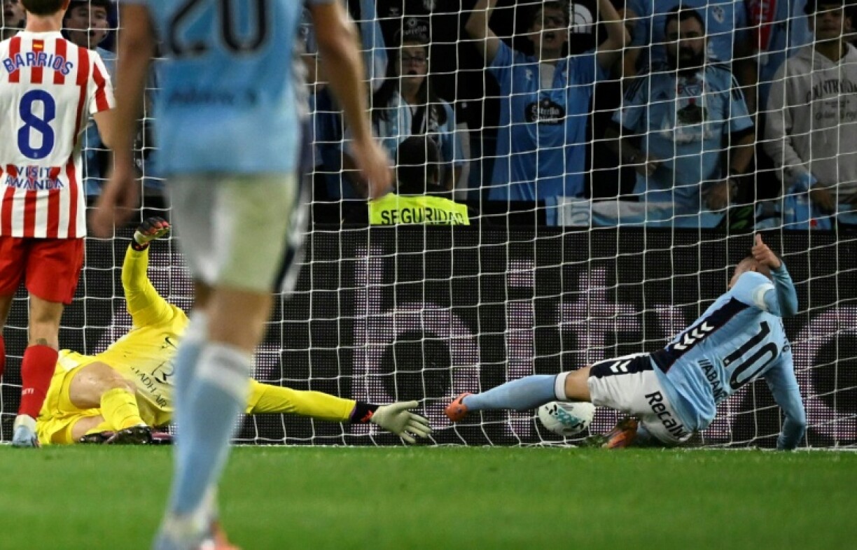 Celta Vigo's Spanish forward Iago Aspas scores his team's equaliser in the draw against Atletico Madrid in La Liga