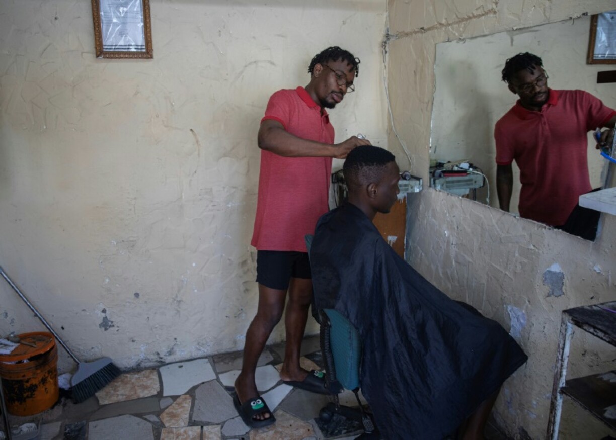 Barber Zilton Macas is a fan of rapper Nikotina, whose music echoes the frustrations of Mozambique's youth