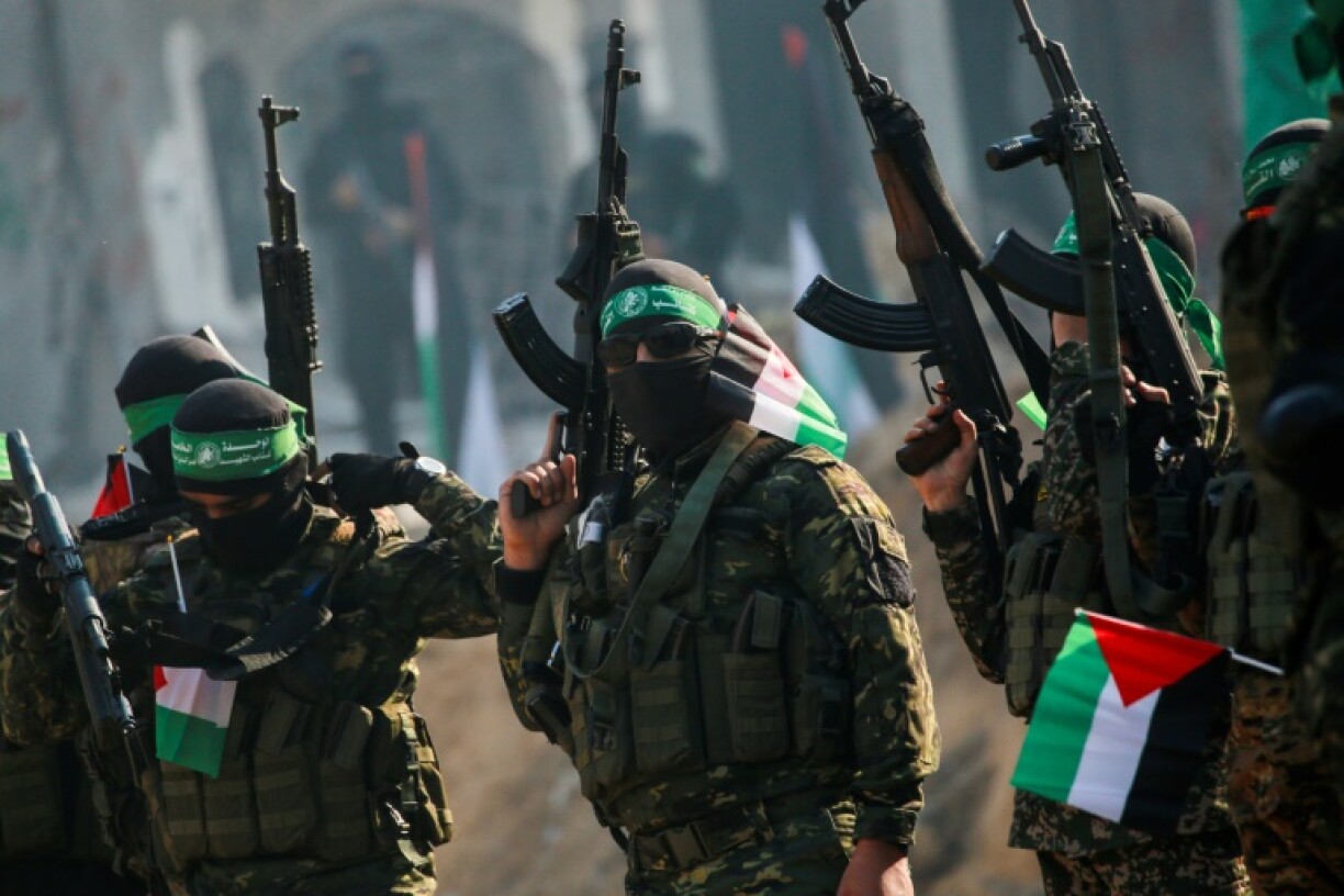 Hamas militants stand guard near a stage before releasing an Israeli hostage