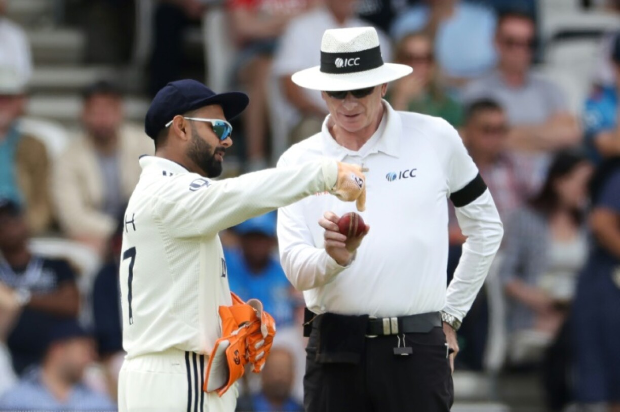 India's Rishabh Pant (L) complains about the shape of the ball to umpire Paul Reiffel (R) during the first Test against England at Headingley