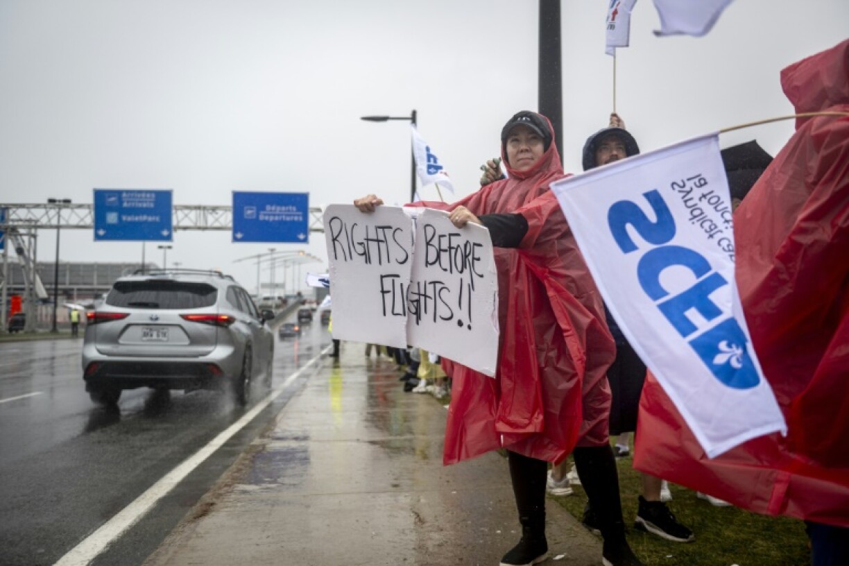 Flight attendants protest in front of Pierre-Elliott Trudeau Airport in Montreal, Canada during a strike over pay in August 2025