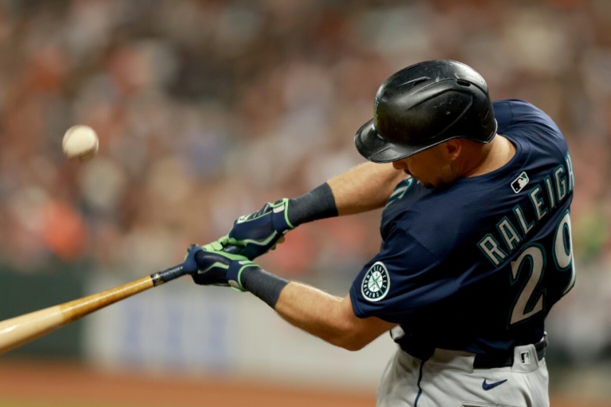 Seattle's Cal Raleigh hit his 57th home run of the MLB season to help the Mariners win at Houston and break the team record for homers in a season he shared with Ken Griffey Jr.