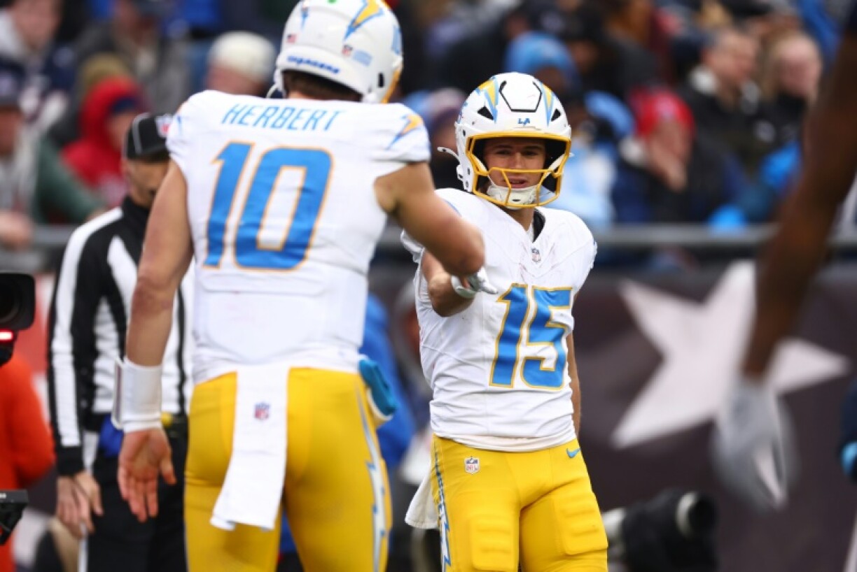 Ladd McConkey of the Los Angeles Chargers celebrates with quarterback Justin Herbert after scoring a touchdown during the second quarter against the New England Patriots.
