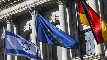 The flags of Israel, the EU and Germany fly in front of the Berlin House of Representatives on 13 October 2025.