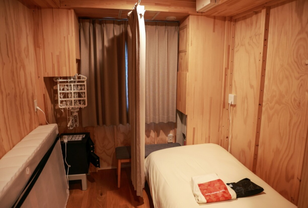 This photo shows a room in a temporary container hut during a press tour of the athletes' rooms