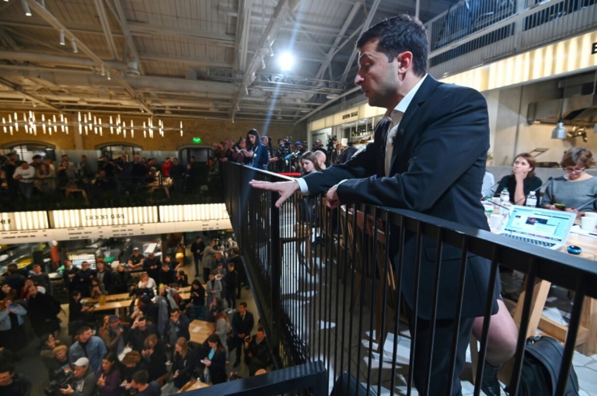 Ukrainian President Volodymyr Zelensky talks to the crowd at a food court in Kiev during his day-long media marathon