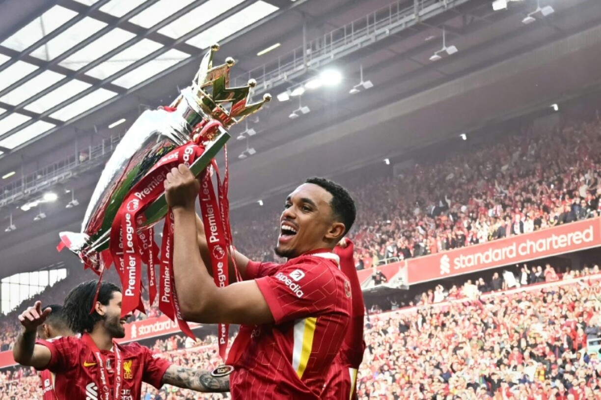 Liverpool's Trent Alexander-Arnold celebrates with the Premier League trophy