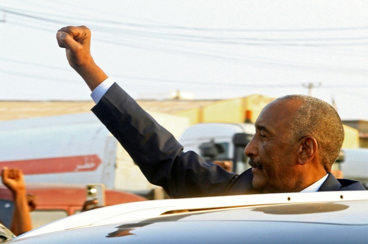 Sudan's army chief Abdel Fattah al-Burhan gestures to people waiting to greet him along a street in Port Sudan on January 14, 2025