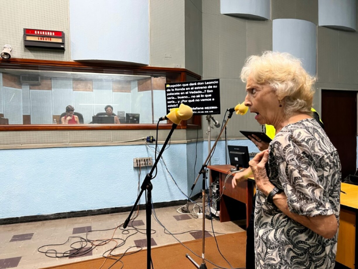 An actress of the Cuban radio soap opera 'Amores en Subasta' records her character's parts at the studio of the Radio Progreso station in Havana