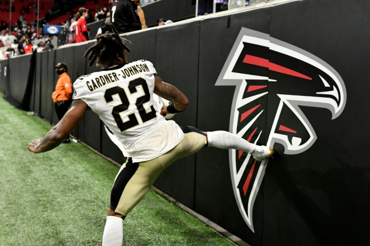 Taking a kicking: a New Orleans Saints player kicks the old Atlanta Falcons logo