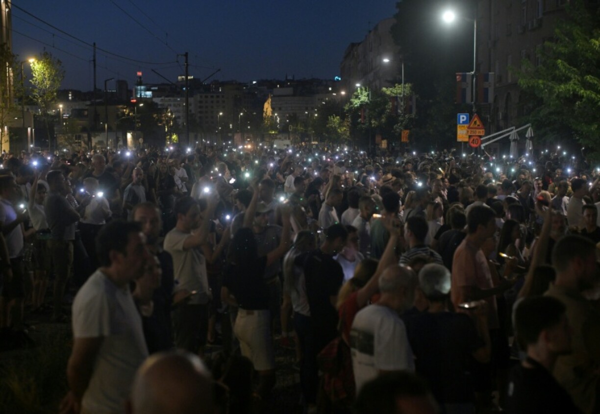 Protesters light up mobile phones as they demonstrate in front of the prosecutors offices calling for the release of their peers who were detained in protests the previous night