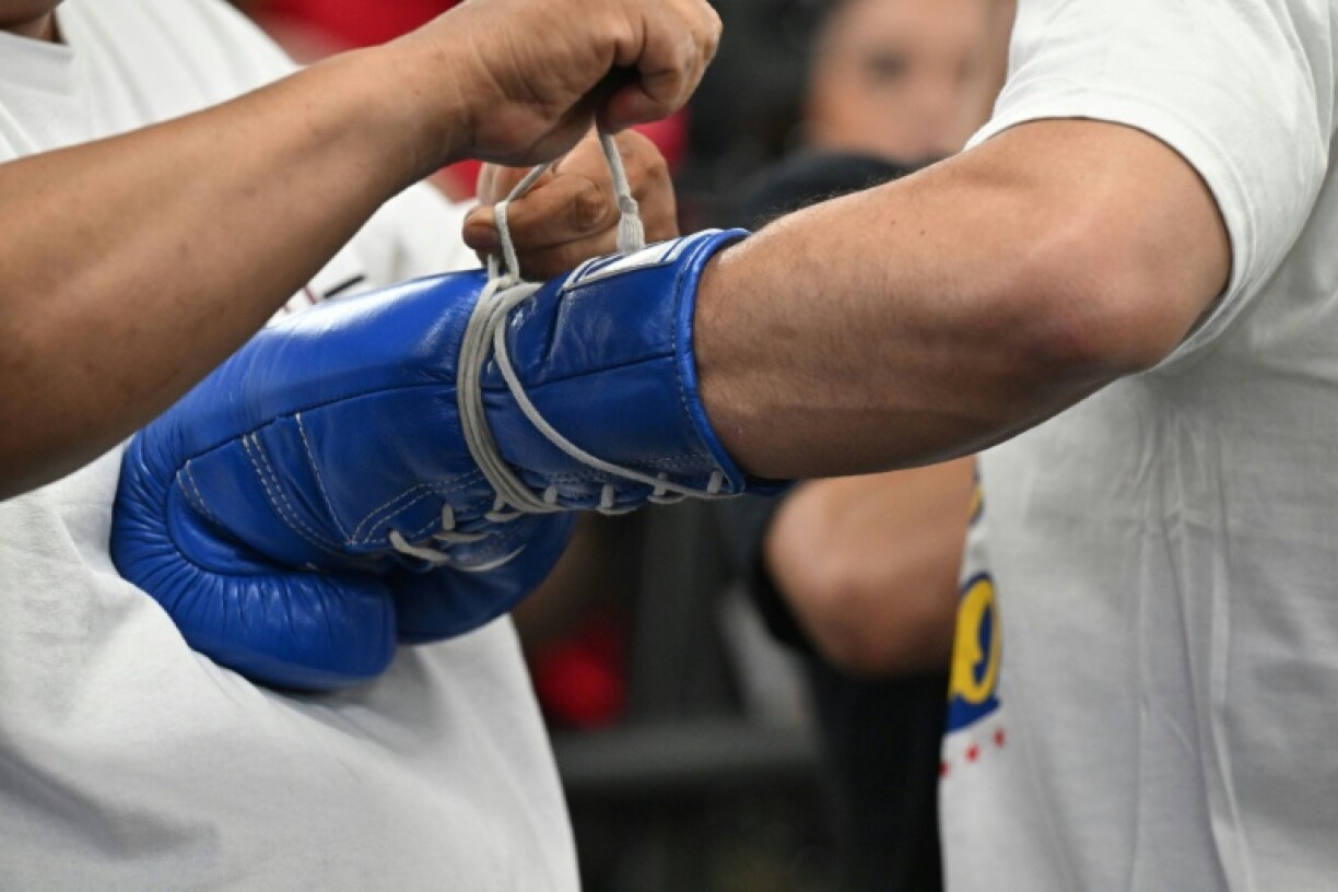 File picture of a trainer lacing up the gloves of Filipino boxer Manny Pacquiao