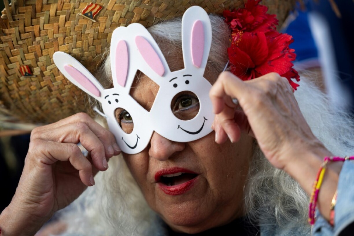 A Bad Bunny wears a rabbit mask as fans wait to see the first concert of his residency