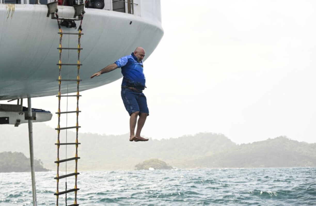 German aerospace engineer Rudiger Koch jumps into the sea to celebrate setting a new world record -- 120 days living underwater