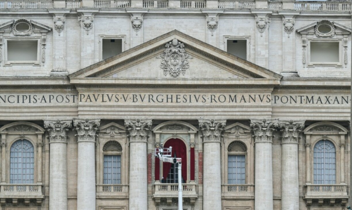A worker prepares the main central balcony of St Peter's basilica
