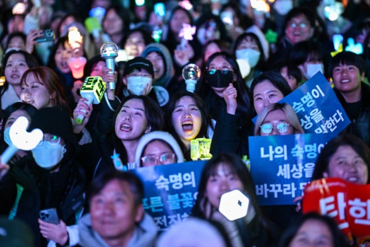 Protesters calling for the ouster of President Yoon Suk Yeol react after the impeachment vote outside parliament
