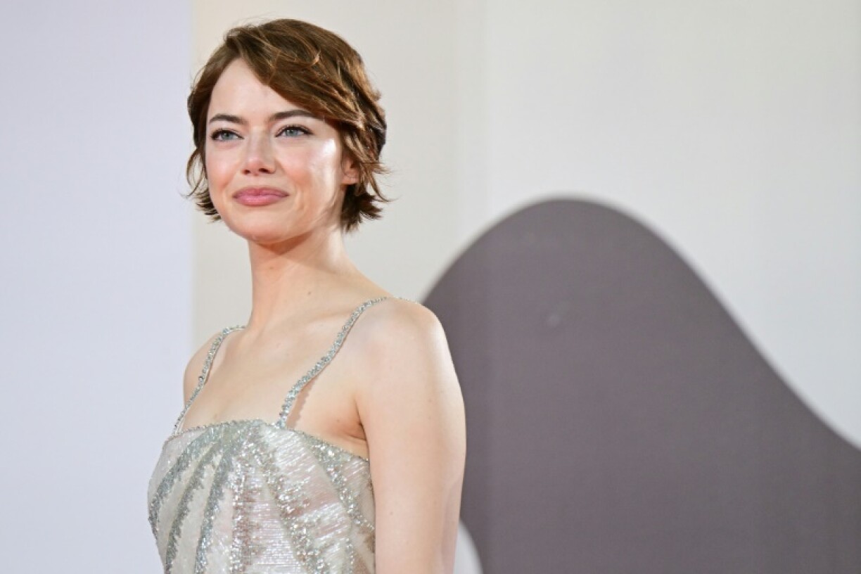 Emma Stone poses on the red carpet before the premiere of 'Bugonia'