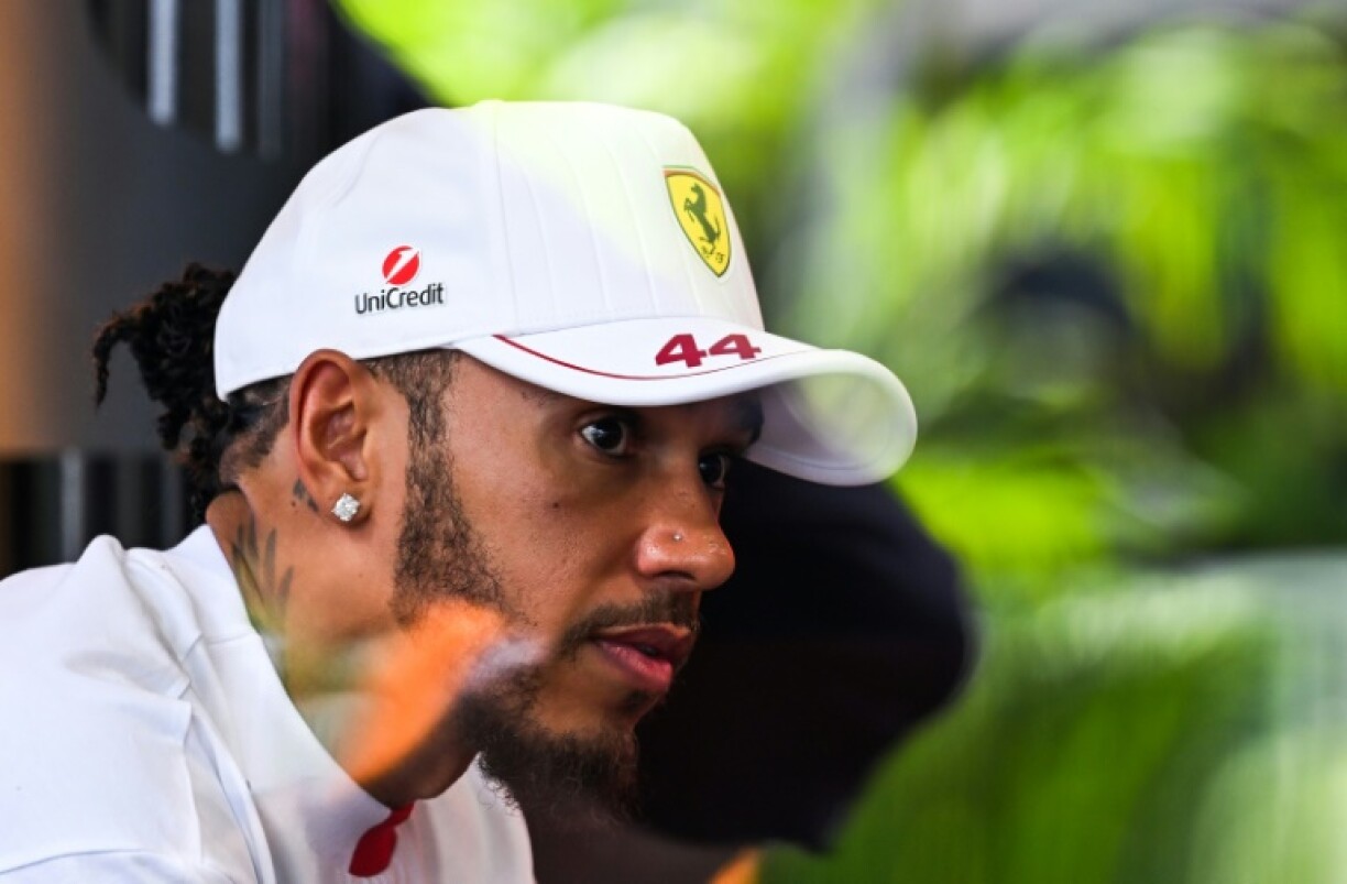 Ferrari's British driver Lewis Hamilton looks on at the F1 team village ahead of the 2025 Miami Formula One Grand Prix.