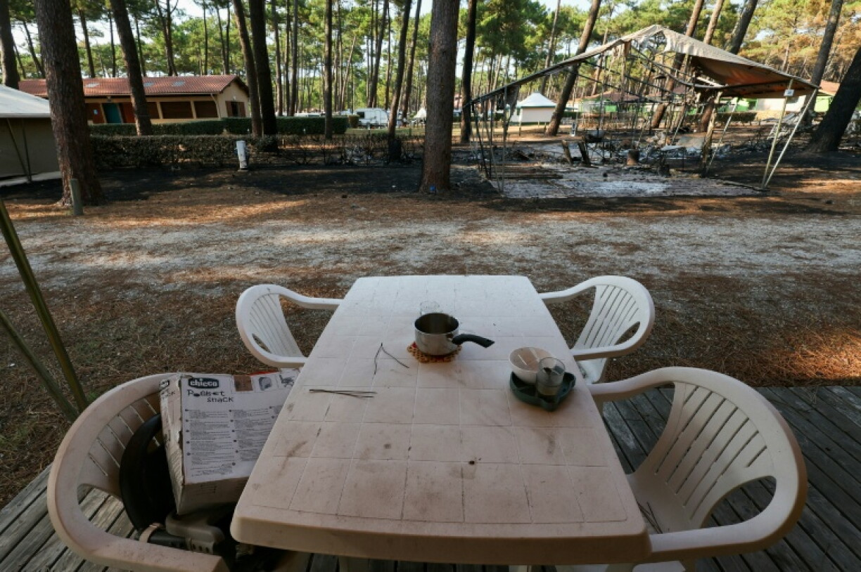 Une table en plastique et du matériel de camping calciné au camping