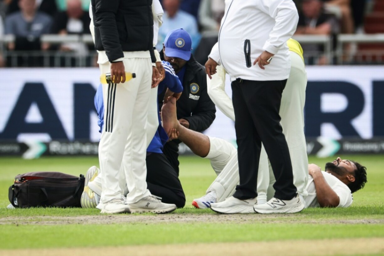 India's Rishabh Pant reacts as he receives medical attention following a foot injury while batting in the fourth Test against England at Old Trafford