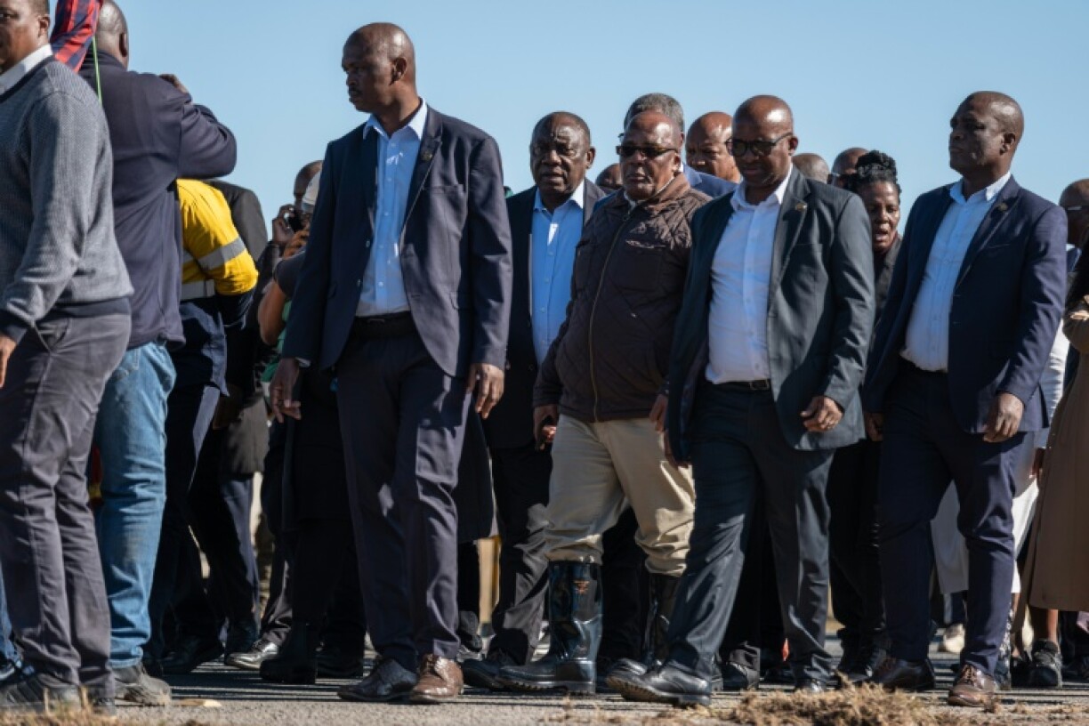 Ramaphosa (C) visited a bridge where a school bus was swept away by the floods