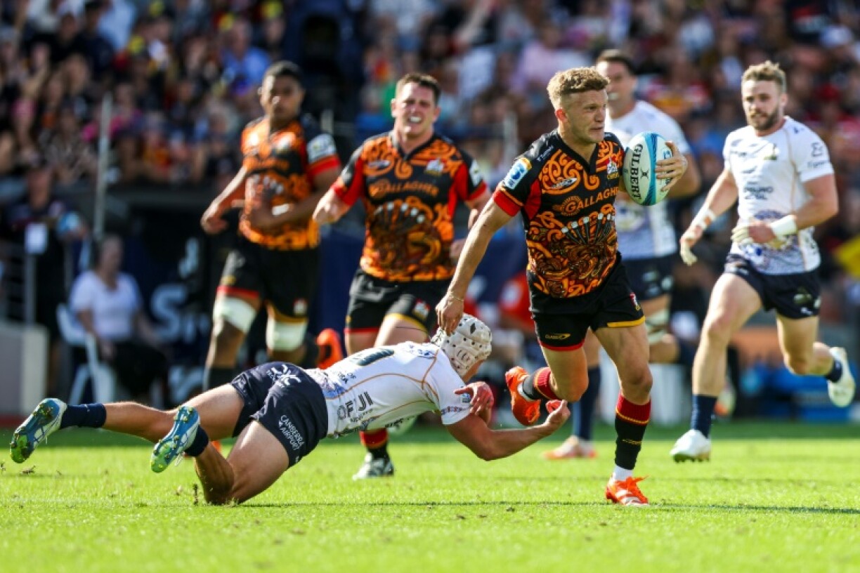 Chiefs' fullback Damian McKenzie evades Declan Meredith of the Brumbies during the Super Rugby Pacific round three match at FMG Stadium in Hamilton
