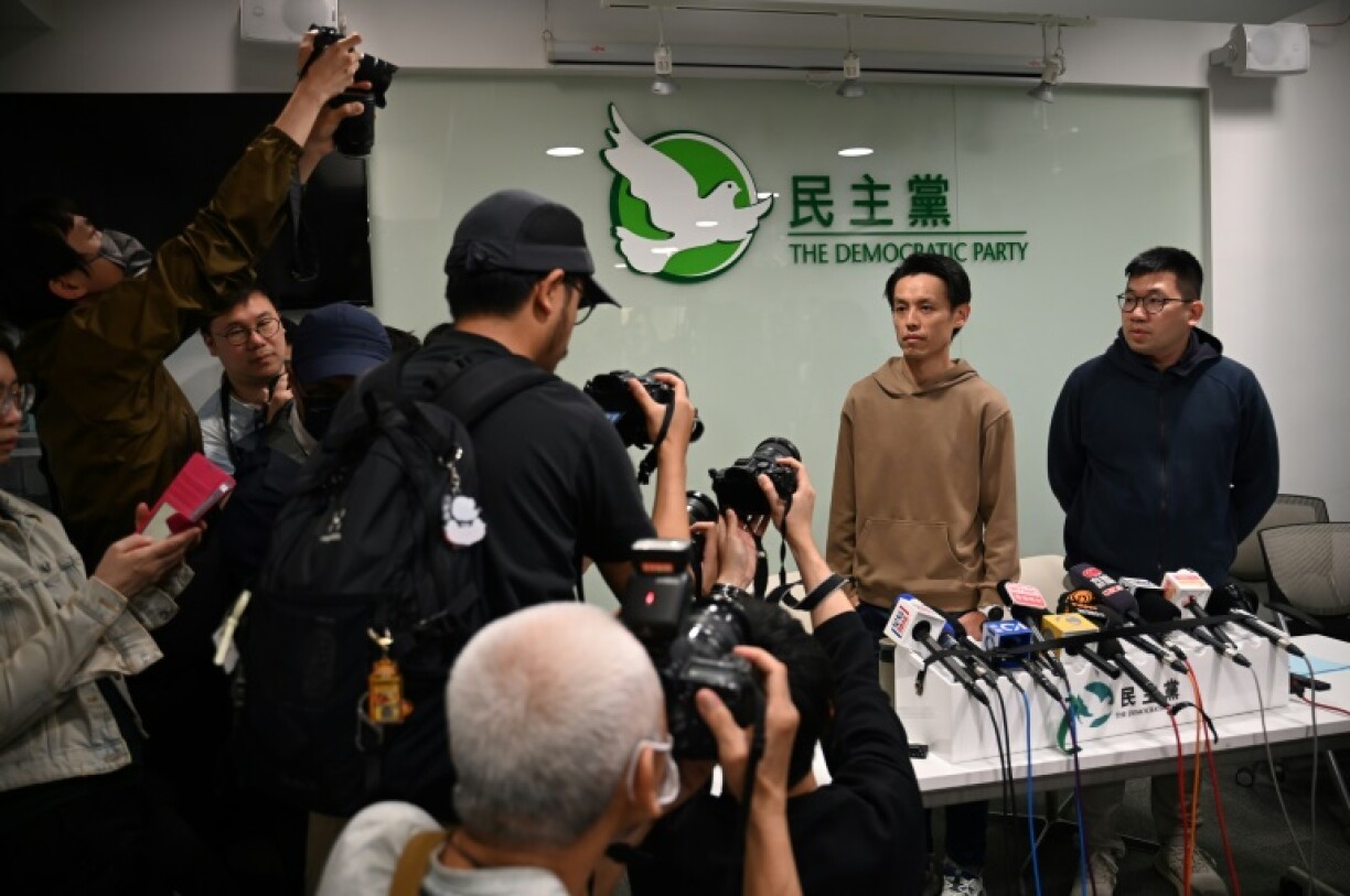 Lo Kin-hei (2nd R), chairman of Hong Kong's Democratic Party (DP), and vice-chairman Mok Kin-shing (R) at a press conference at the party's headquarters in Hong Kong on April 13, 2025